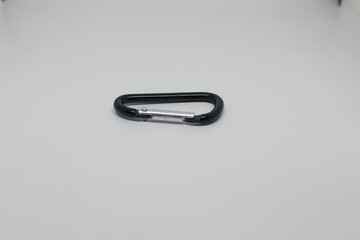 Black and silver aluminium carabiner on a white background