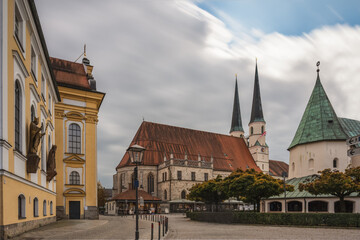 Obraz premium Tillyplatz Altötting, Kirchen mit Wolken im Herbst