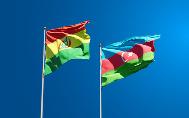Beautiful national state flags of Azerbaijan and Bolivia together at the sky background. 3D artwork concept.