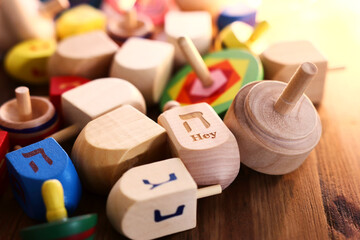Banner of jewish holiday Hanukkah with wooden dreidels (spinning top) over wooden background