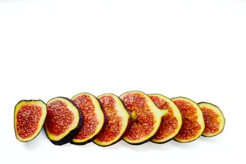 Bright juicy ripe figs on a white background cut into pieces. The concept of healthy food.