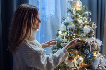 Home new year. Happy laughing young woman in a white sweater