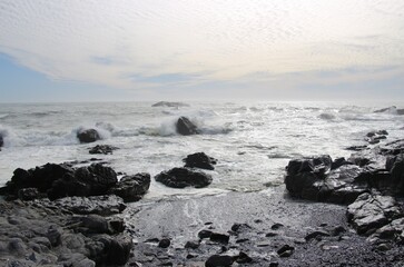 On the shore of the wild atlantic ocean in Yzerfontein, South Africa. Rocks and waves.