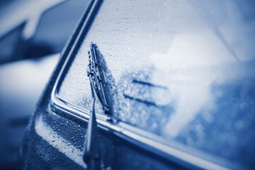 The rear window of the car and the black windshield wiper were wet from heavy rain. Bad weather....