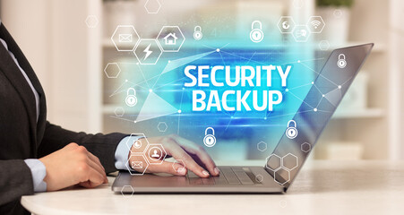 SECURITY BACKUP inscription on laptop, internet security and data protection concept, blockchain...