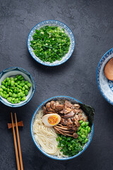 Shio ramen soup with chicken, mushrooms, onion and egg, flat lay copy space