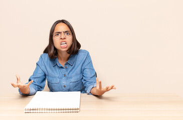 young woman looking angry, annoyed and frustrated screaming wtf or what’s wrong with you