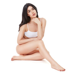 Fototapeta premium Fitness young woman with a beautiful body sitting on white background
