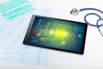 Tablet pc and medical stuff with X-RAY inscription, prevention concept