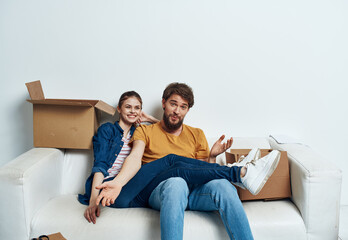 young couple in the room housewarming boxes with things moving emotions fun