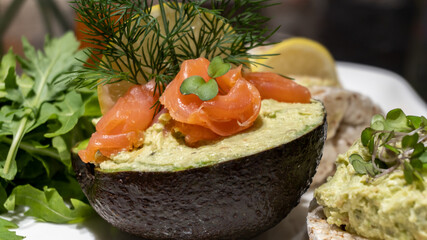 Toasts of  bread with avocado slices, red tomatoes and microgreen. 