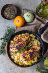 Grilled spicy chicken breast or fillet with pumpkin and aromatic herbs in iron pan. Healthy food. Top view.