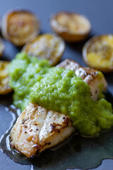 frilled cod fish with green asparagus pea sauce and fried potatoes