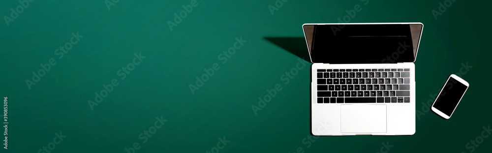 Poster laptop computer with a smartphone from above