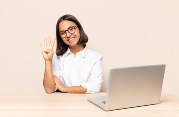smiling and looking friendly, showing number four or fourth with hand forward, counting down