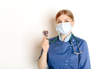 Medical woman doctor with stethoscope on white background. Female nurse wearing surgical mask. Caucasian woman portrait