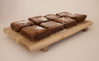 Closeup shot of chocolate brownies on a wooden board