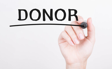 Hand writing Donor with black marker on transparent wipe board