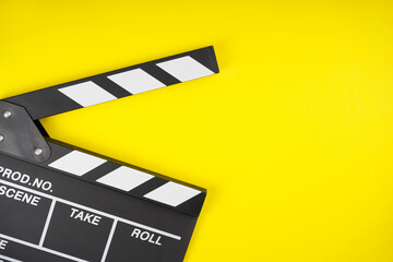Fototapeta na wymiar Clapperboard on yellow background. Movie, filmmaking, cinema concept. Top view, flat lay, copy space