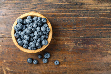 Fresh blueberries in a wooden bowl