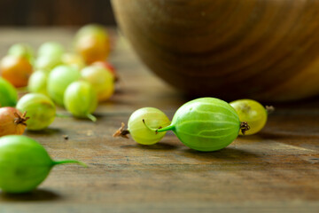Sweet fresh gooseberry berry on wood table.