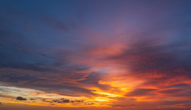 Abstract amazing Scene of stuning Colorful sunset with Moving clouds background in nature and travel concept, wide angle shot Panorama shot.