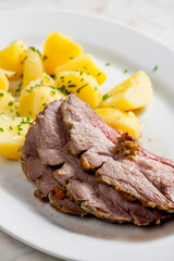 slowly roasted lamb on garlic with potatoes