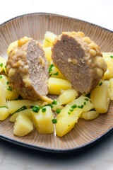 meat ball baked with beans and cheese served with potatoes