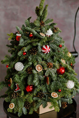 Fototapeta na wymiar Christmas tree with toys on green branches