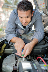 Man fixing a car engine