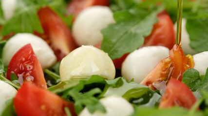 caprese salad with mini mozzarella, tomatoes cherry and arugula
