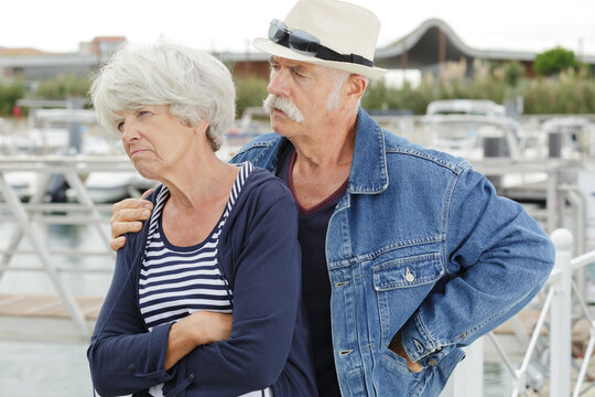 Senior Man Trying To Console Grumpy Wife