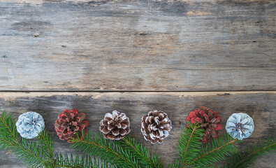 Template for christmas greeting card. Pine cones and fir branches on old non paint wooden...