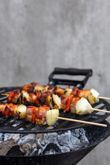 skewer with red pepper onion and smoked pork on a garden grill