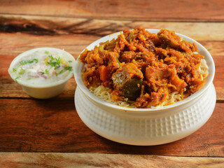 Traditional hyderabadi Vegetable / veg dum biryani with mixed veggies served with mixed raita, selective focus