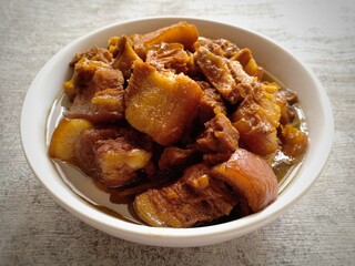 Babi kecap is an Indonesian braised pork with sweet soy sauce. It is a Chinese Indonesian classic food. Pork belly is the main ingredient in this food. Very tasty and delicious. Served on white bowl