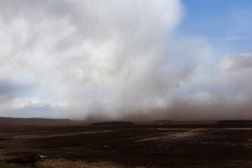 dust from peat excavations flying against the sky