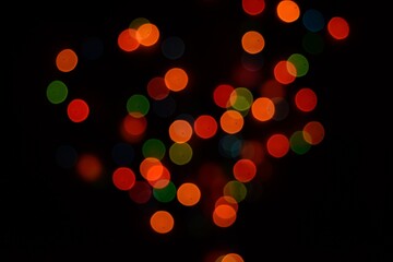 The multicolored side's or boke on a black background. Merry Christmas and happy New Year. Christmas background.