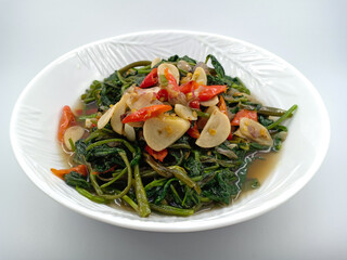 Indonesian healthy food. Sauté water spinach or kale with garlic and red chilli. Water spinach contains good vitamins and garlic as a healthy antioxidant. Vegetarian food menu. Isolated on white