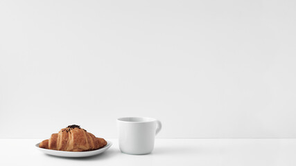 Mug and croissants on a white background. Eco-friendly and natural materials in the decor, dessert. Copy space, mock up