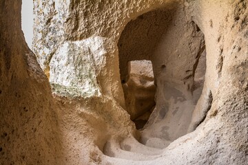 Stairs built inside the rock in Uchhisar Castle. It's a large rock formation full of small rooms and  corridors. It attracts visitors with its intriguing history. Cappadocia. Turkey.