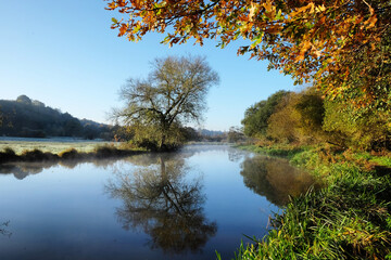 A still River Wey on a cold sunny morning in Godalming, Surrey, UK