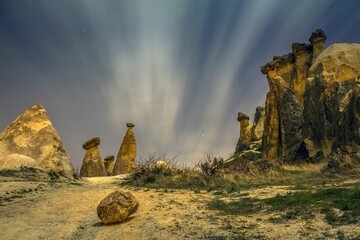 Volcanic rock formations and amazing morning sky with light clouds. Cappadocia, Turkey. This rocky wonderland was shaped by millions of years of natural phenomena.