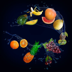 Fototapeta na wymiar Panorama with fruits in splashes of water - juicy grapefruit, grapes, kiwi, orange, pineapple, banana, pear, avocado are full of vitamins and are very beneficial for our health