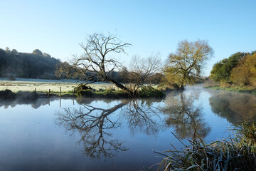 A still River Wey on a cold sunny morning in Godalming, Surrey, UK