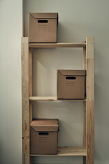 Paper boxes are on a wooden rack. Archive storage, use of eco-friendly materials