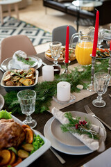 Festive table served with homemade orange juice, roasted potatoes with turkey