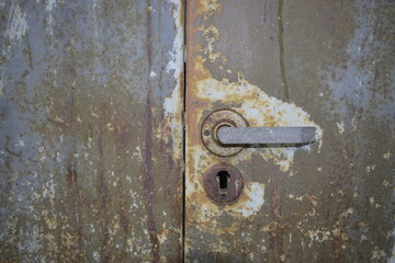 Old rusty texture of metal safe with a handle.