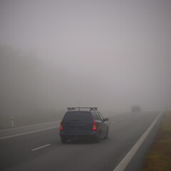 Plakat Bad weather driving - foggy hazy country road. Motorway - road traffic. Winter time.