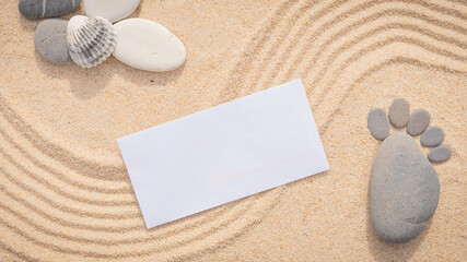 Fototapeta na wymiar Arrière-plan grains de sable de mer, sable fin de plage avec enveloppe et coquillages. Emplacement pour texte sur papier. 